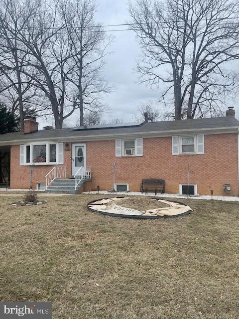 rear view of house with a lawn