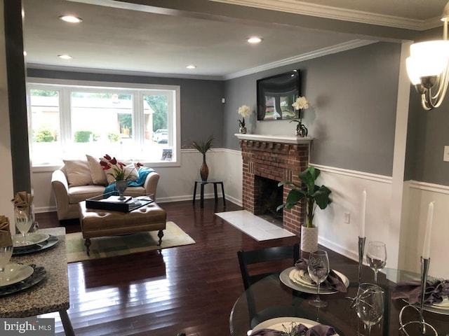 living room with crown molding, dark hardwood / wood-style floors, and a fireplace