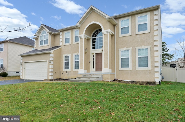 view of front of house with a garage and a front lawn