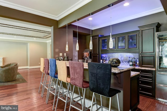 bar featuring ornamental molding, dark wood-style flooring, and a dry bar