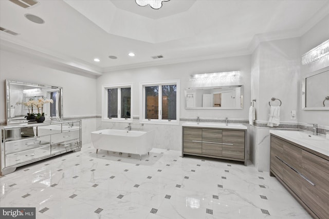 full bathroom with a sink, a soaking tub, visible vents, and crown molding