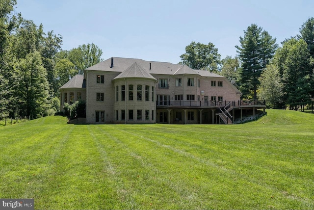 back of house featuring stairs, a yard, and a wooden deck