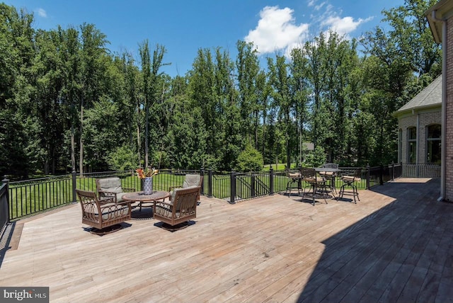 wooden deck with outdoor dining area and a lawn