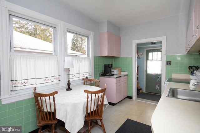 dining area with sink and tile walls