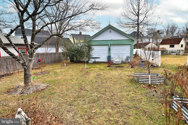 view of yard with a garage and an outdoor structure