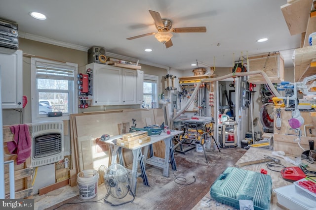 misc room featuring crown molding, ceiling fan, concrete flooring, and heating unit