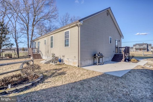 view of side of property with a patio area