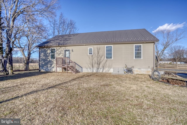 back of house featuring a lawn