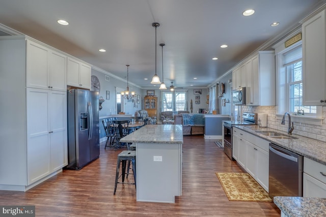 kitchen with white cabinetry, a kitchen island, and appliances with stainless steel finishes