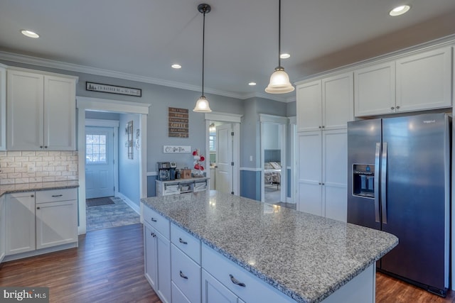 kitchen featuring a center island, stainless steel refrigerator with ice dispenser, white cabinets, dark hardwood / wood-style flooring, and decorative light fixtures