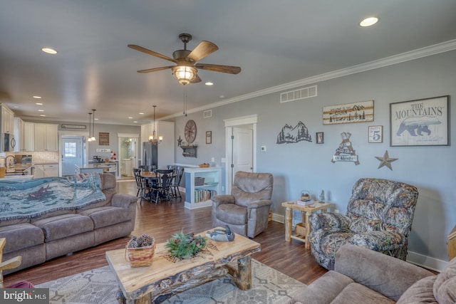 living room featuring ceiling fan, ornamental molding, dark hardwood / wood-style flooring, and sink