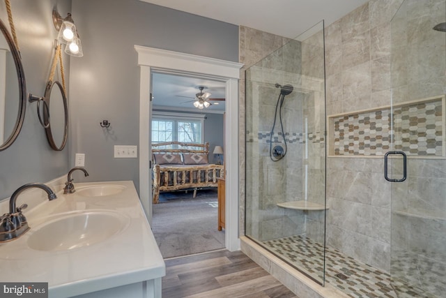 bathroom with walk in shower, wood-type flooring, and vanity