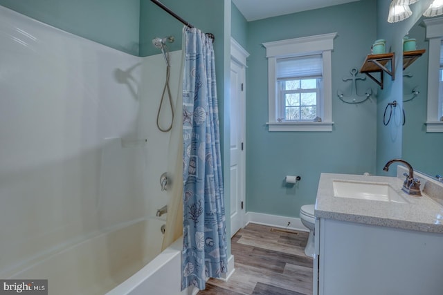 full bathroom with shower / tub combo with curtain, vanity, wood-type flooring, and toilet