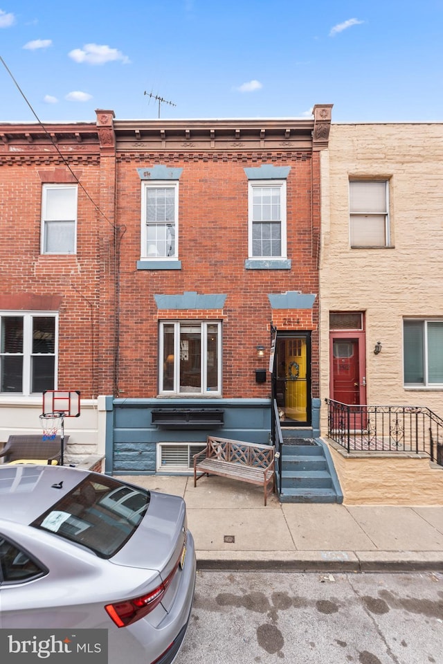 view of property with brick siding