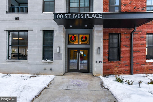 view of snow covered property entrance