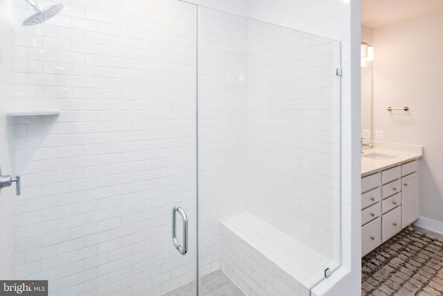 bathroom featuring vanity and an enclosed shower