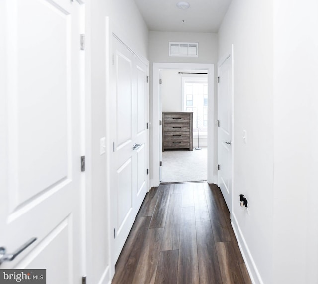 corridor featuring dark hardwood / wood-style flooring