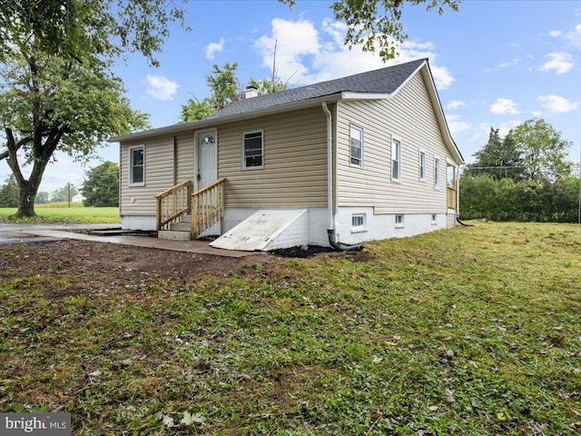 rear view of house with a yard