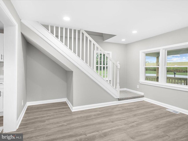 stairs featuring hardwood / wood-style flooring