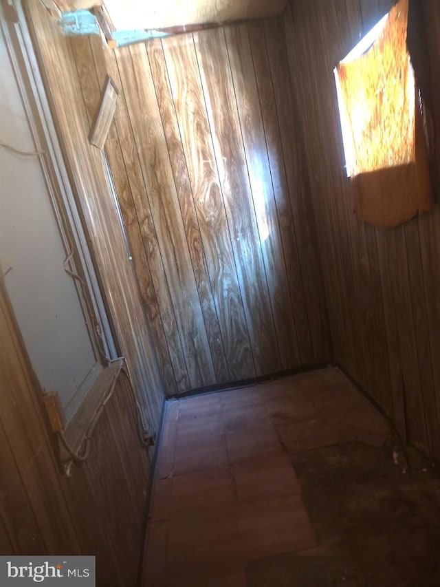 interior space featuring wood-type flooring and wood walls