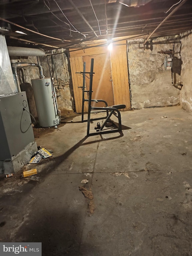 basement featuring gas water heater and heating unit