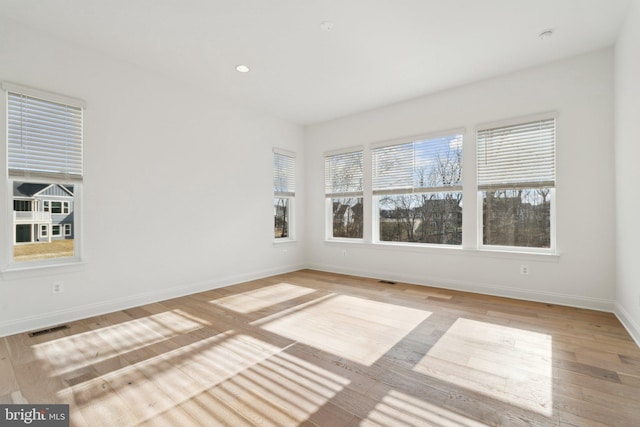 unfurnished room with light hardwood / wood-style floors