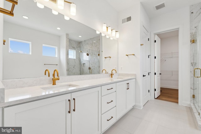 bathroom with vanity and a shower with shower door