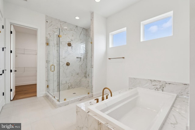 bathroom featuring shower with separate bathtub