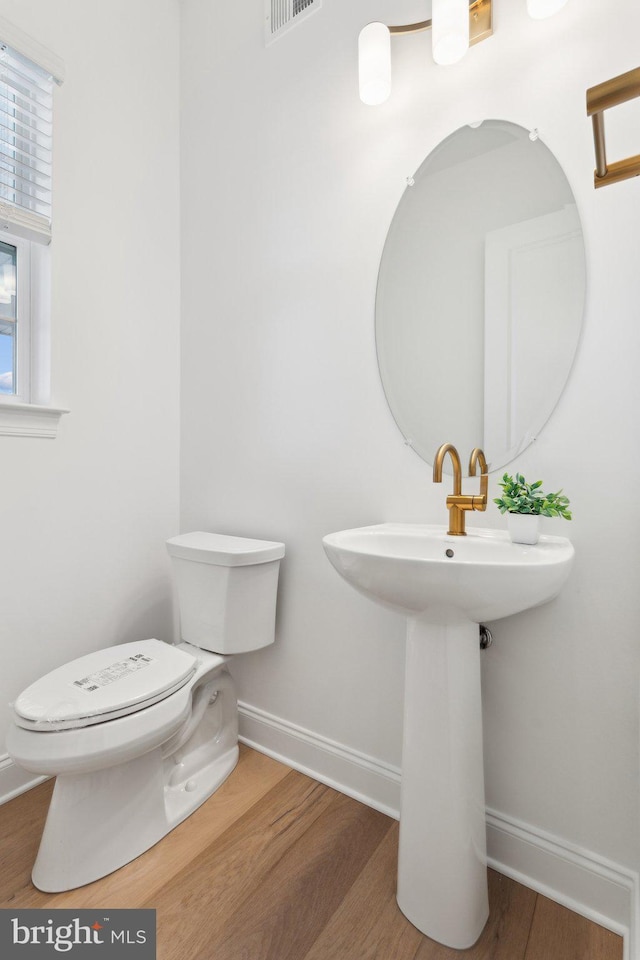 bathroom featuring sink, toilet, and hardwood / wood-style floors