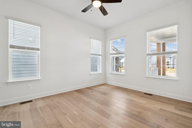 unfurnished room with ceiling fan, plenty of natural light, and light hardwood / wood-style flooring