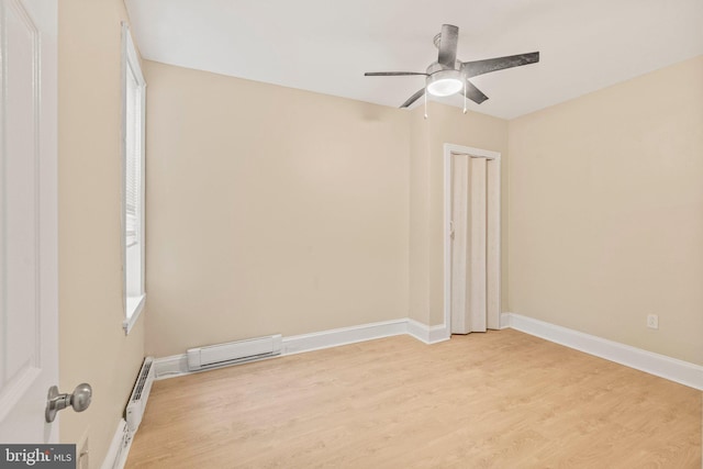 spare room with ceiling fan, light hardwood / wood-style flooring, and a baseboard radiator