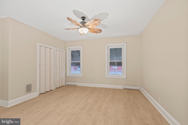 spare room featuring ceiling fan and light hardwood / wood-style floors