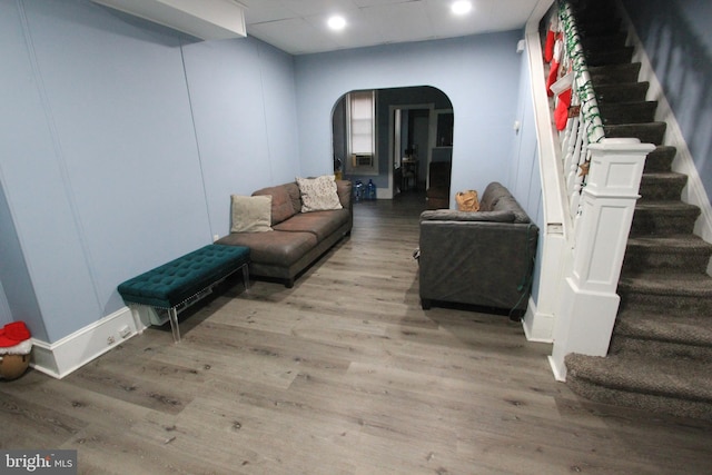 living room with a drop ceiling and light hardwood / wood-style flooring