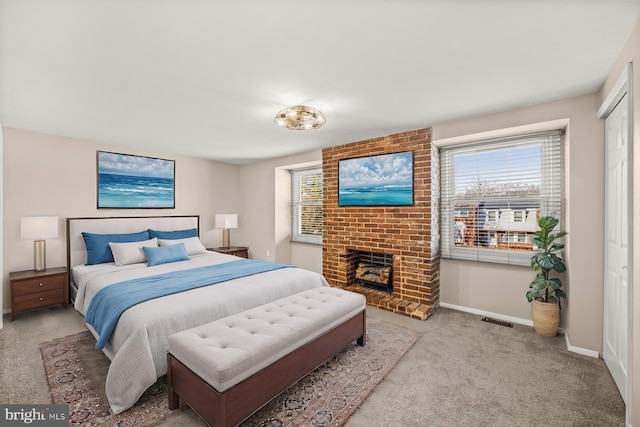 bedroom featuring light carpet and a fireplace