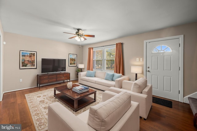 living room with dark hardwood / wood-style floors and ceiling fan