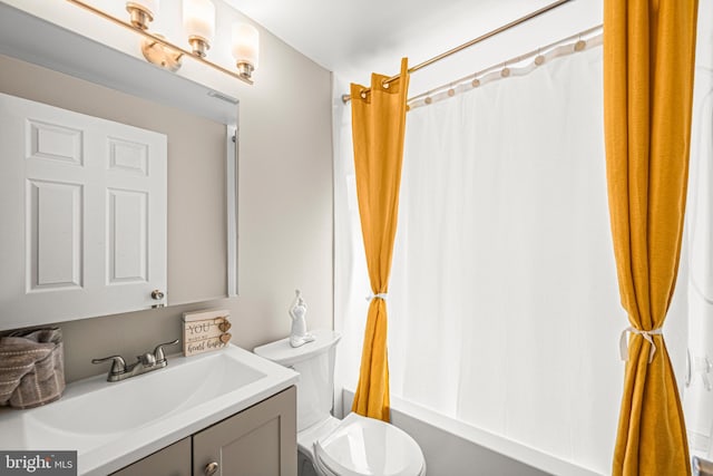 full bathroom featuring vanity, toilet, and shower / bath combination with curtain