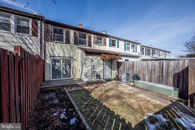 rear view of property featuring cooling unit