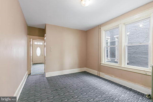 443 Manor St, Lancaster, PA 17603 - empty room featuring dark carpet and baseboards