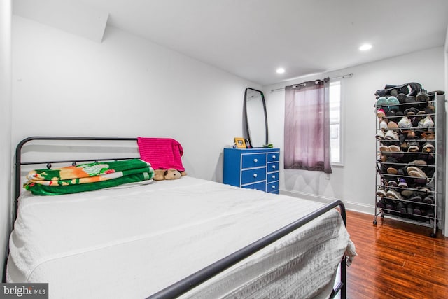 bedroom with dark hardwood / wood-style floors