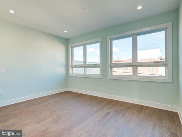 empty room with hardwood / wood-style floors