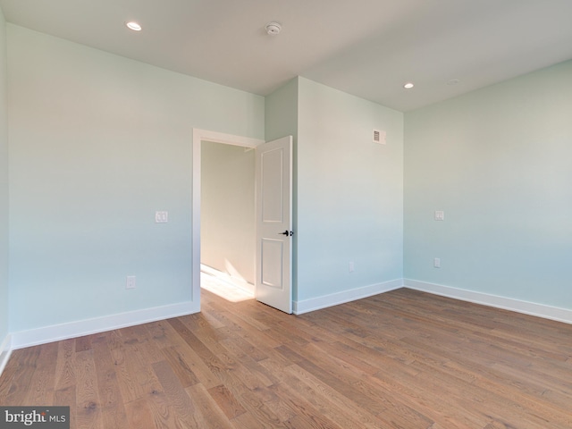 empty room with hardwood / wood-style floors