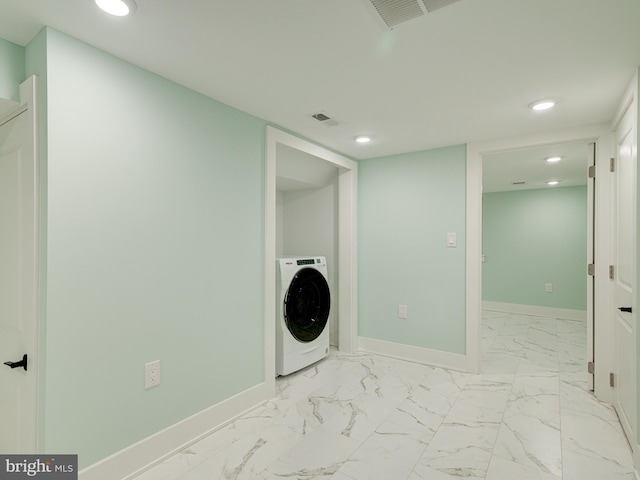 clothes washing area featuring washer / dryer