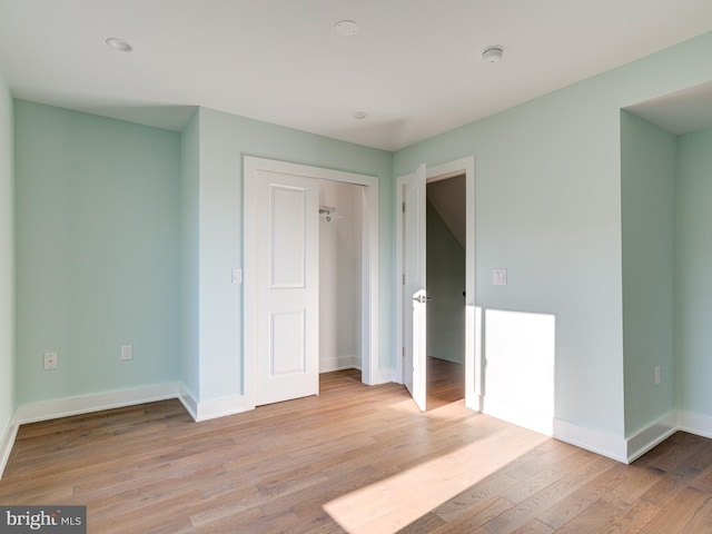 unfurnished bedroom with light hardwood / wood-style floors and a closet