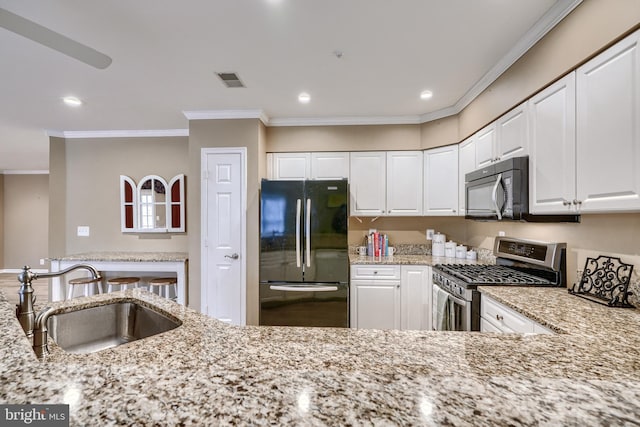 kitchen featuring white cabinets, light stone countertops, sink, and black appliances