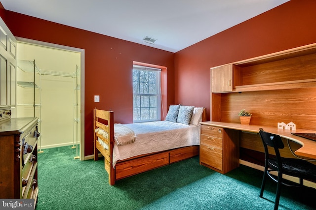 carpeted bedroom featuring a spacious closet