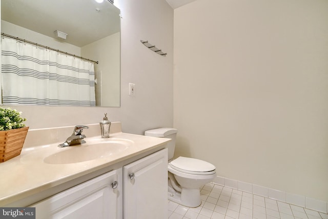 bathroom featuring tile patterned flooring, vanity, and toilet