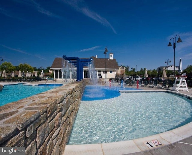 view of pool with pool water feature