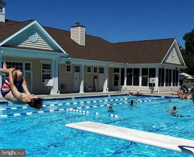 view of pool featuring a diving board