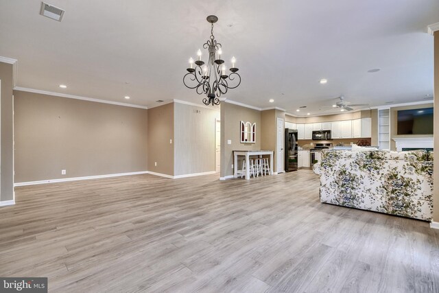 unfurnished living room featuring crown molding, ceiling fan with notable chandelier, and light wood-type flooring