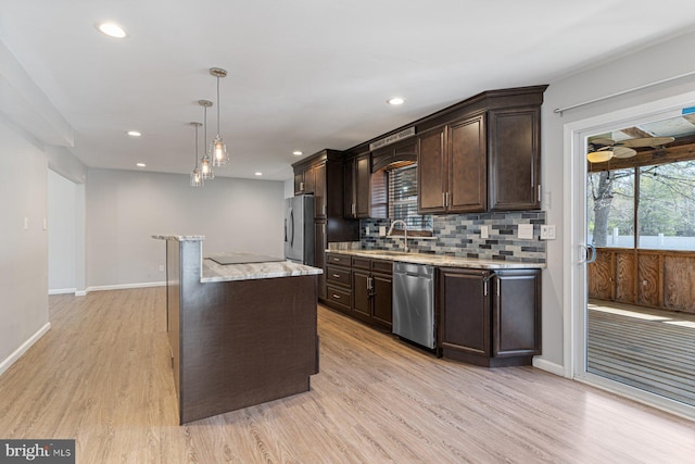 1762 Red Oak Ln, Waldorf, MD 20601 - kitchen featuring a center island, dark brown cabinets, a wealth of natural light, appliances with stainless steel finishes, and a sink